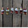 Box of six hanging glass Christmas stocking ornaments.